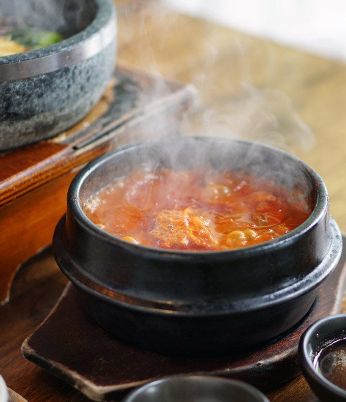 Kimchi Tofu Soup served in clay pot, One of the most-loved of all the stews in Korean cuisine, Most popular food in Korea.